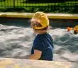 girl playing on sand box
