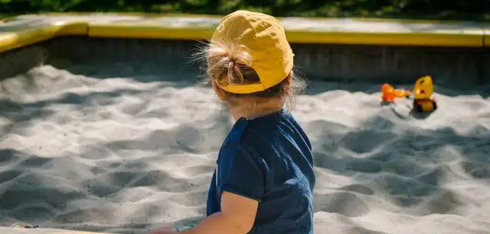 girl playing on sand box
